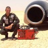 Image of Andy Green next to Thrust SSC which was the only vehicle to break the sound barrier and achieved 763 mph
