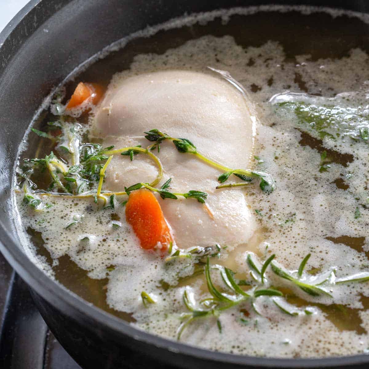 chicken in less than boiling water, being poached
